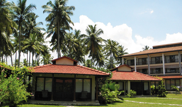Weligama Bay Resort Sri Lanka villa exteriors with palm trees overlooked by hotel