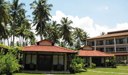 Weligama Bay Resort Sri Lanka villa exteriors with palm trees overlooked by hotel