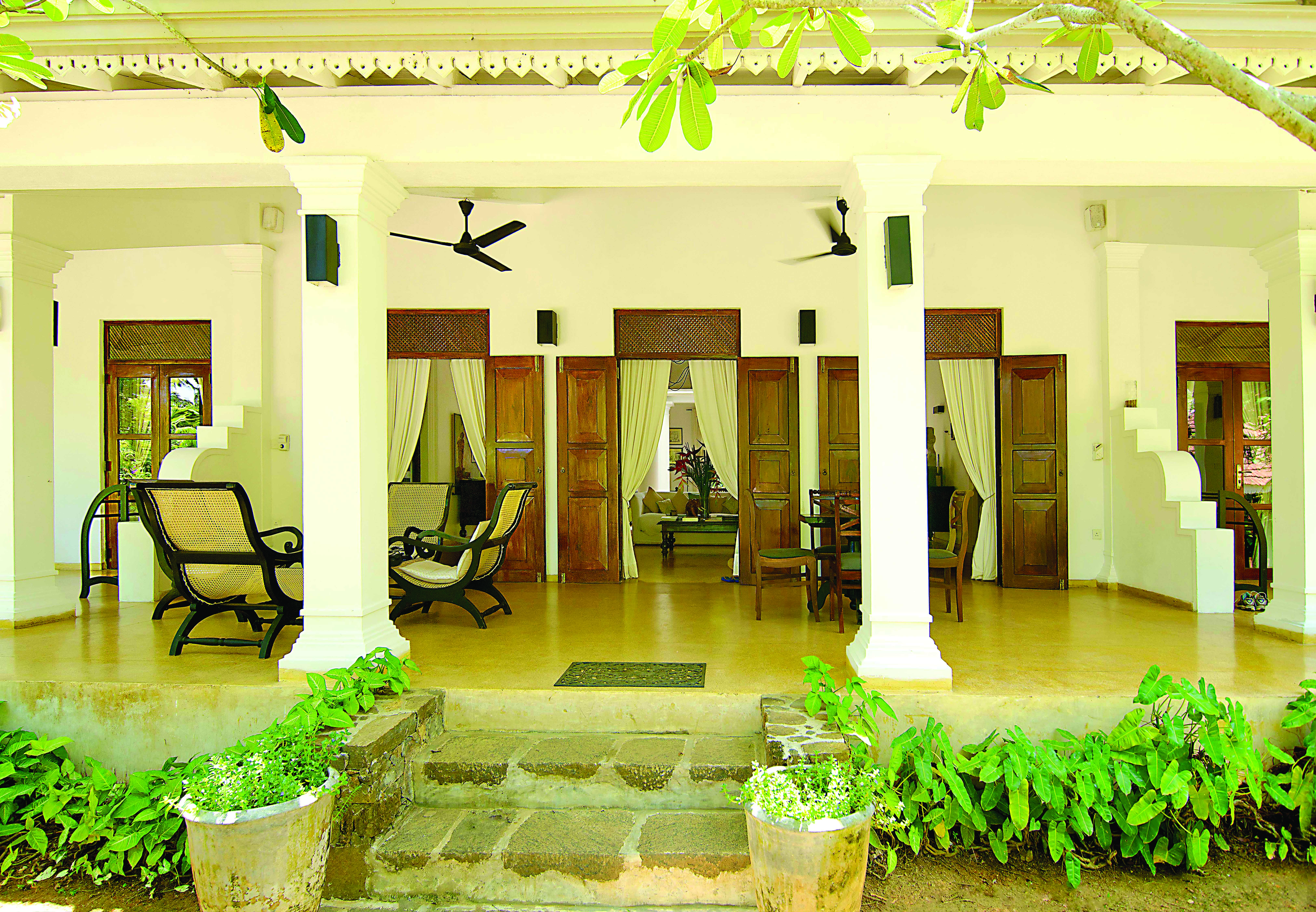 Why House Sri Lanka veranda covered outdoor seating area chairs columns trees