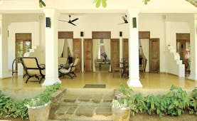 Why House Sri Lanka veranda covered outdoor seating area chairs columns trees