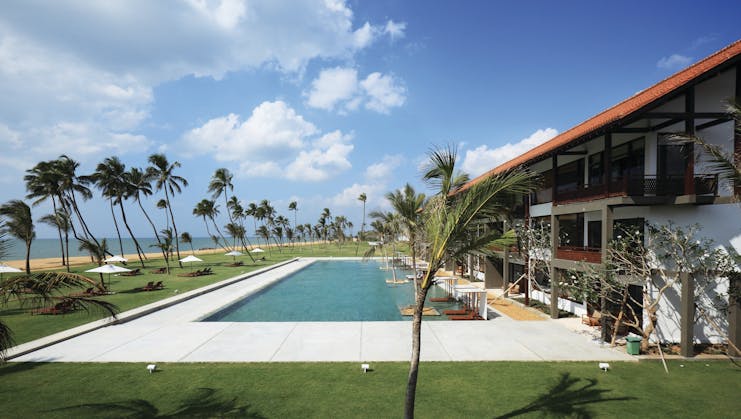 Anantaya Chilaw Resort Sri Lanka poolside sun loungers umbrellas palm trees ocean views