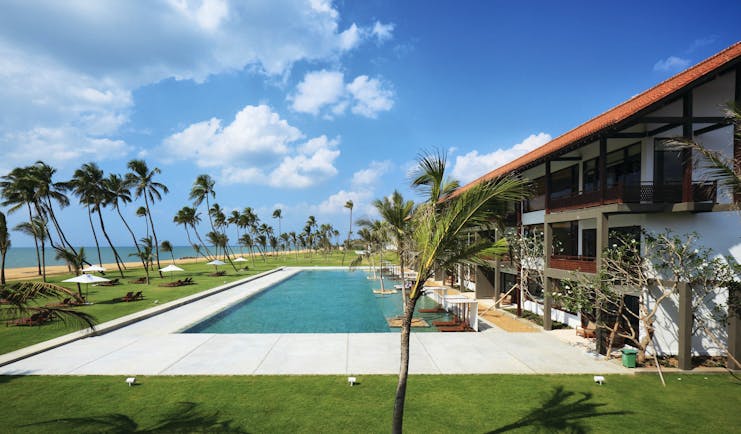 Anantaya Chilaw Resort Sri Lanka poolside sun loungers umbrellas palm trees ocean views