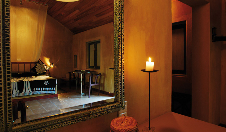 Ayurveda Pavilions Sri Lanka bedroom reflected in large ornate mirror