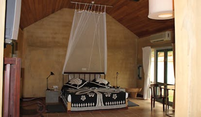 Ayurveda Pavilions Sri Lanka large bedroom black and white bed mosquito drapes