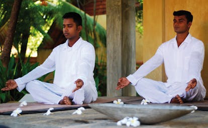 Ayurveda Pavilions Sri Lanka yoga two men in white practicing yoga