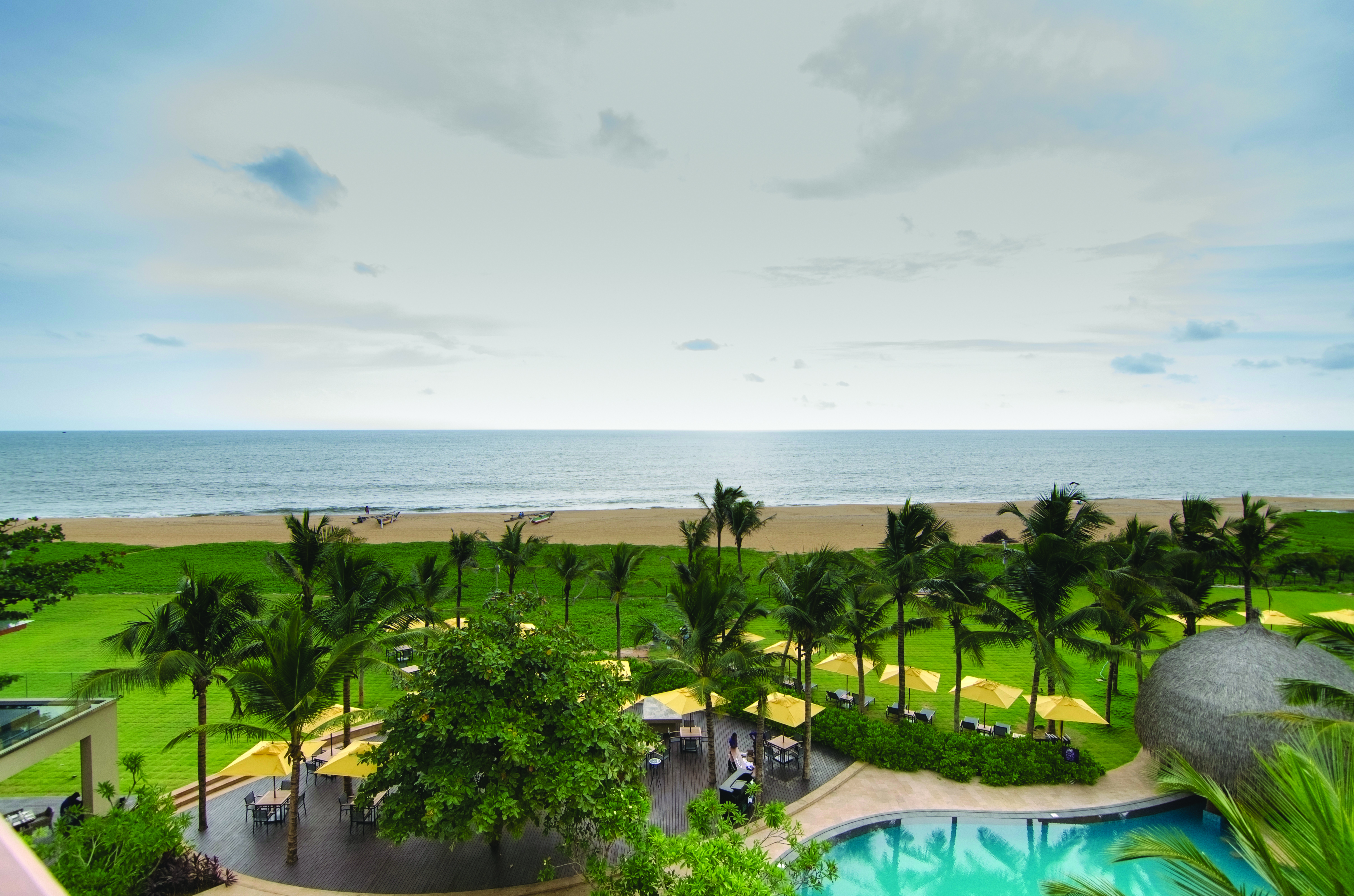 Heritance Negombo Sri Lanka beach view pool trees lawn sand sea