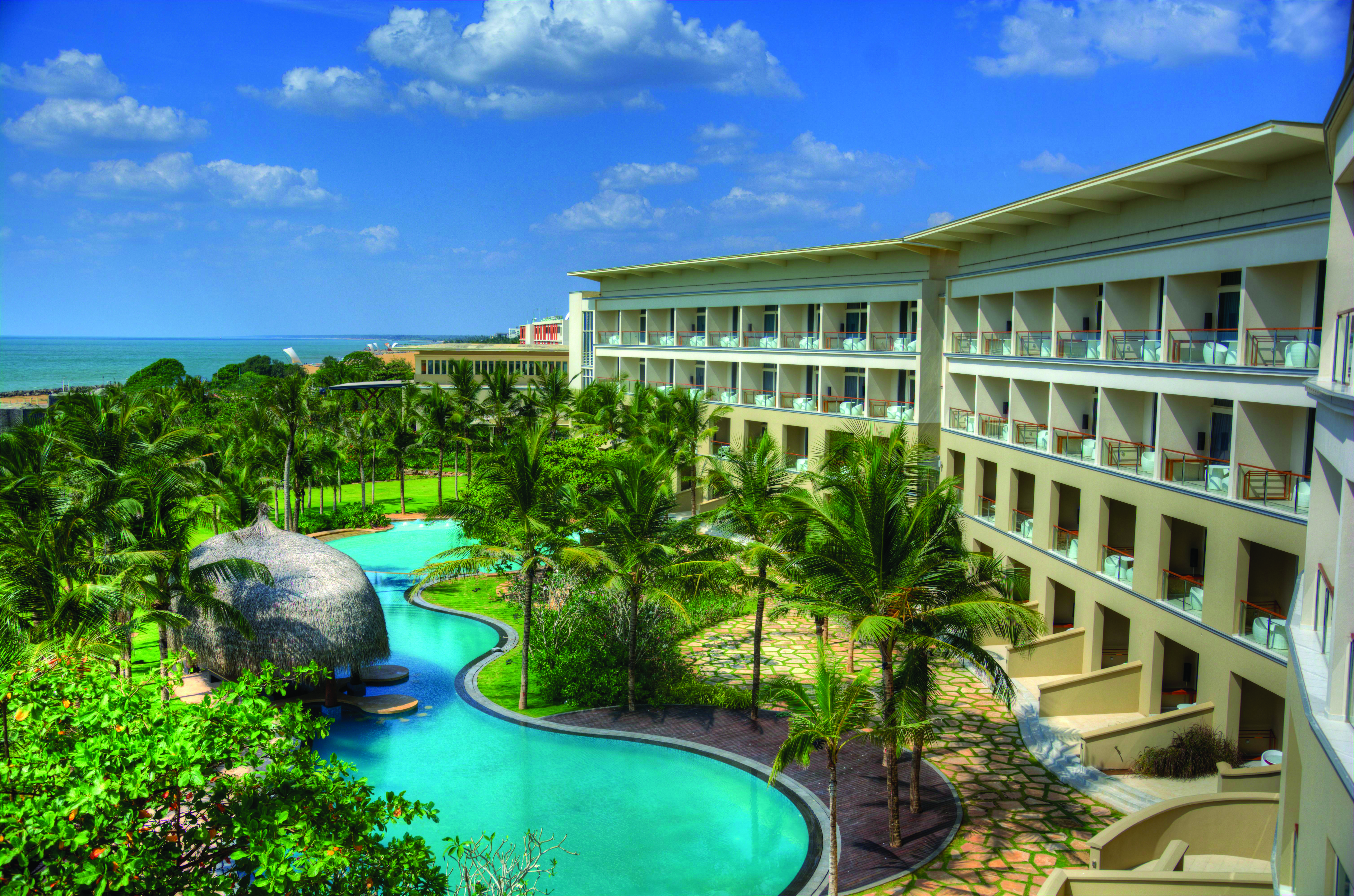 Heritance Negombo Sri Lanka exterior hotel building pool trees lawn ocean in background