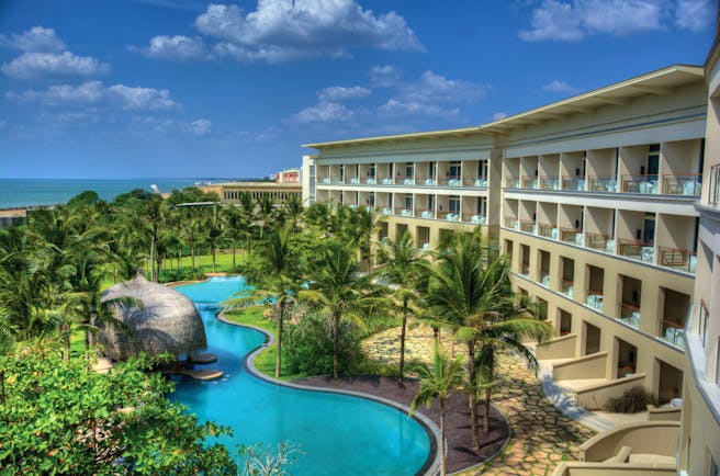 Heritance Negombo Sri Lanka exterior hotel building pool trees lawn ocean in background