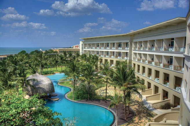 Heritance Negombo Sri Lanka exterior hotel building pool trees lawn ocean in background