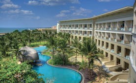 Heritance Negombo Sri Lanka exterior hotel building pool trees lawn ocean in background
