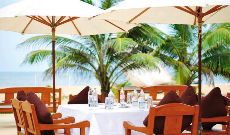 Jetwing Beach Sri Lanka outdoor dining white table umbrellas trees