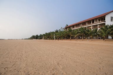Jetwing Blue Sri Lanka beach long sandy beach palm trees hotel building