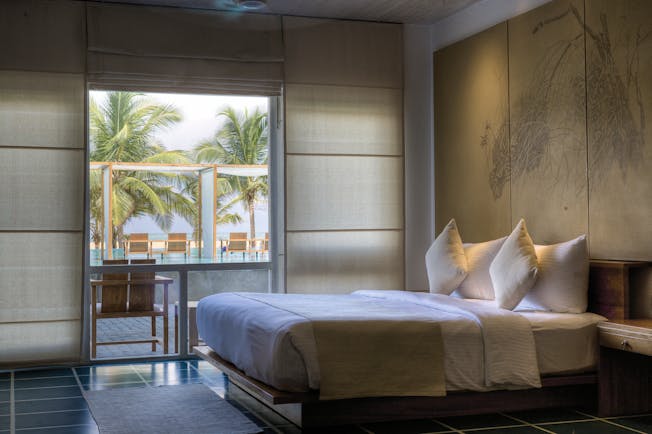 Jetwing Blue Sri Lanka deluxe room bed window overlooking pool modern décor