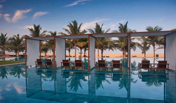 Jetwing Blue Sri Lanka pool sun loungers umbrellas palm trees