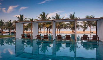 Jetwing Blue Sri Lanka pool sun loungers umbrellas palm trees