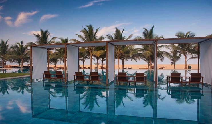 Jetwing Blue Sri Lanka pool sun loungers umbrellas palm trees