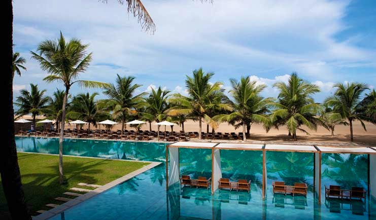 Jetwing Blue Sri Lanka poolside palm trees umbrellas sun loungers