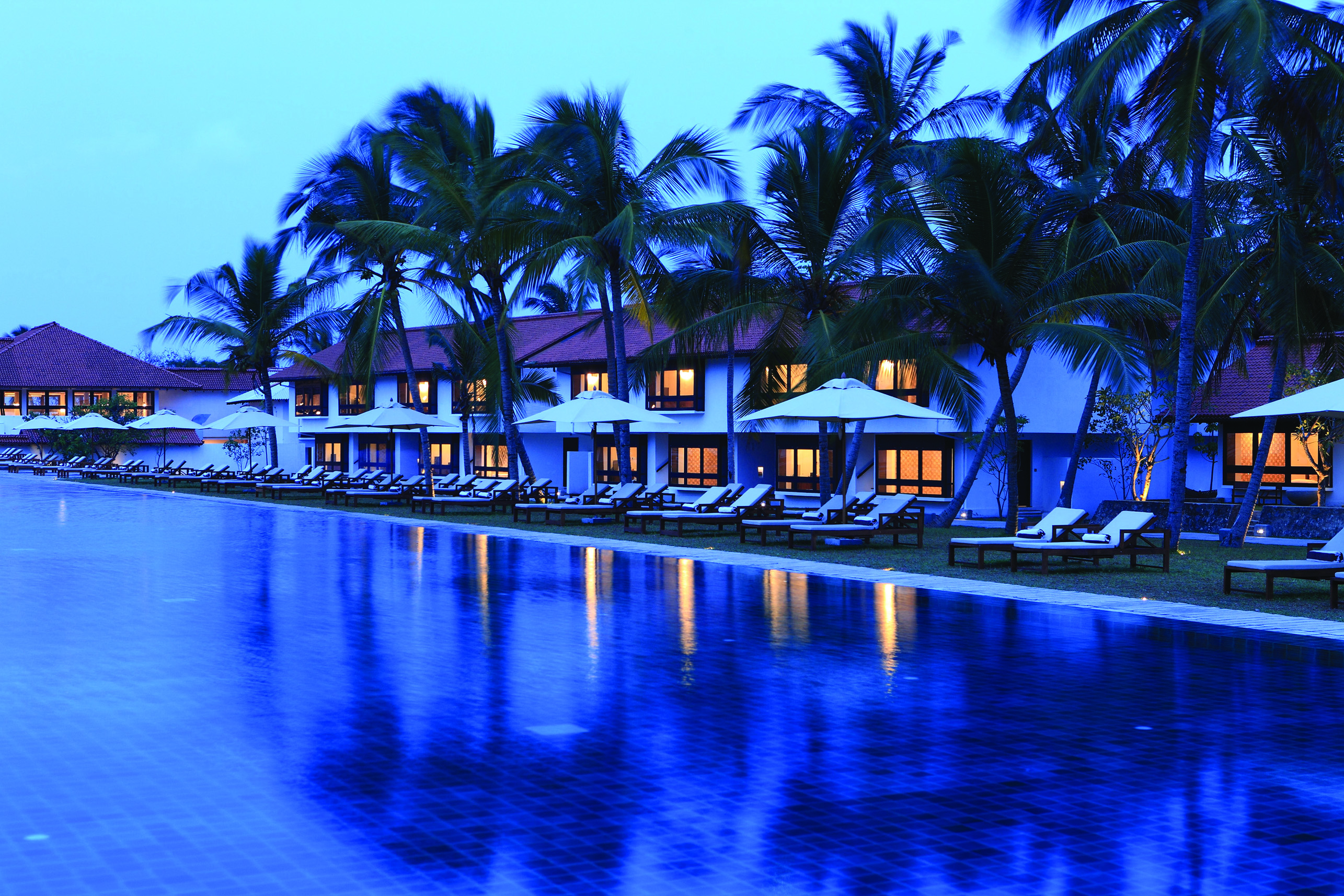 Jetwing Lagoon Sri Lanka pool palm trees sun loungers umbrellas