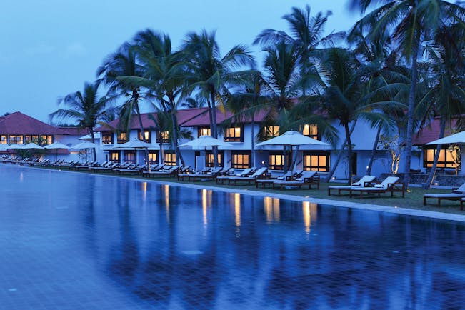 Jetwing Lagoon Sri Lanka pool palm trees sun loungers umbrellas