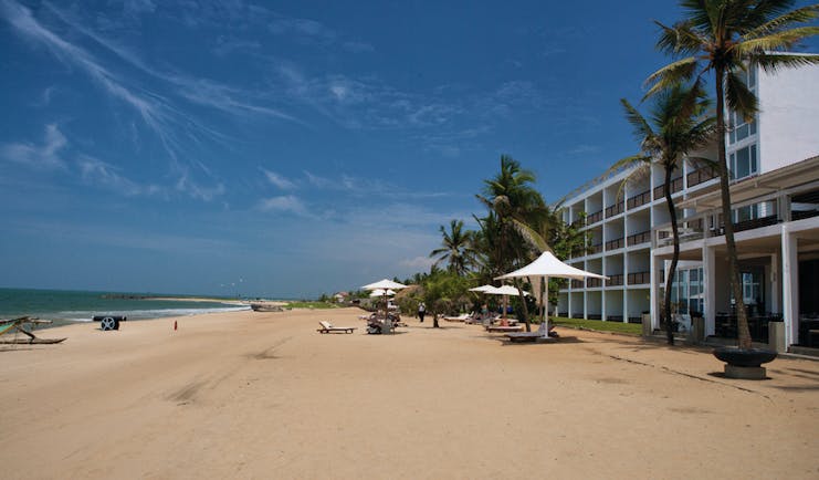 Jetwing Sea Sri Lanka beach sand umbrella palm tree sun loungers