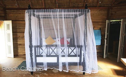 Palagama Beach beach cabana bedroom, canopied double bed, wooden walls, traditional decor