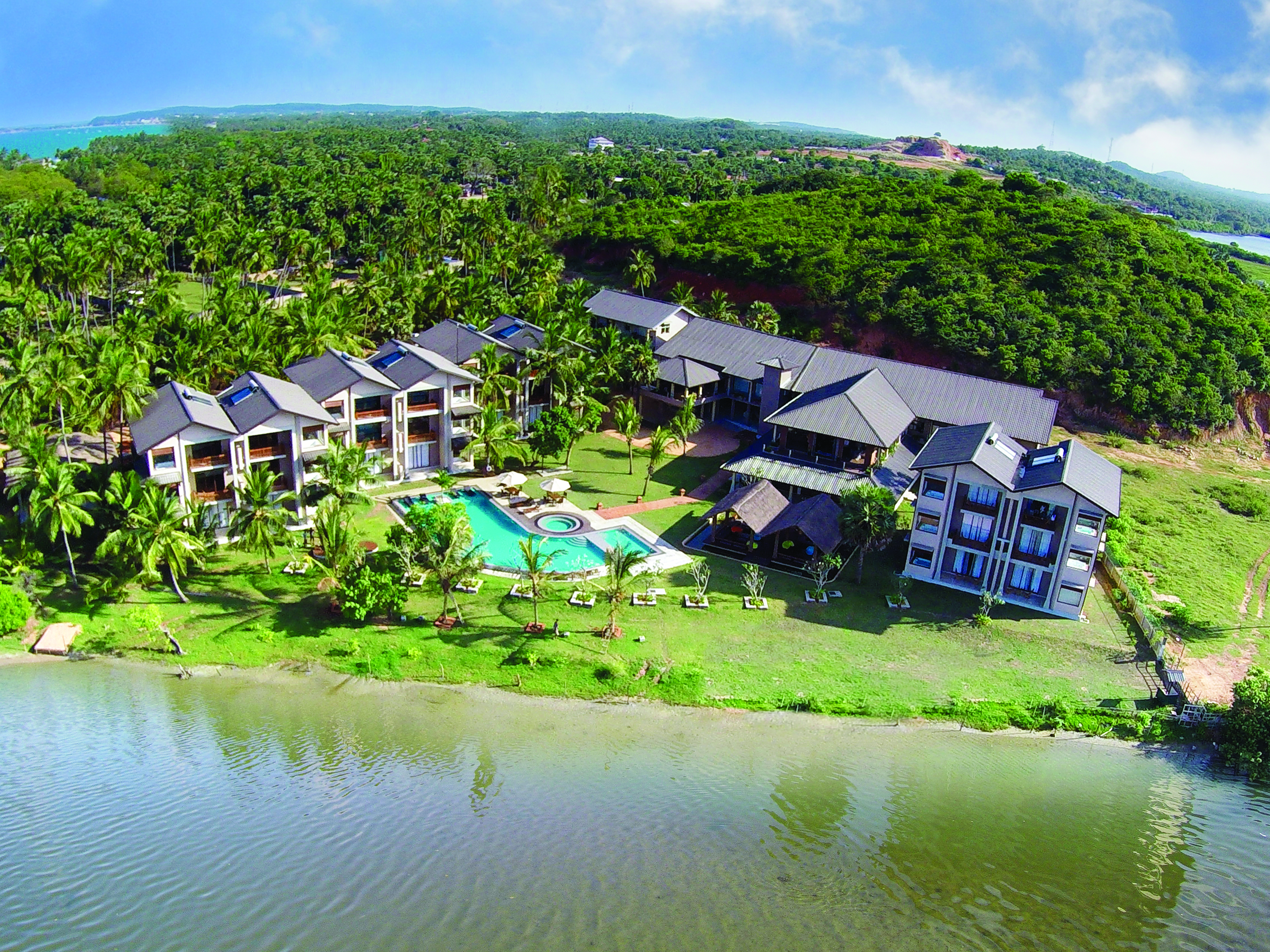 Aramanthe Bay Sri Lanka aerial hotel buildings pool gardens forest background