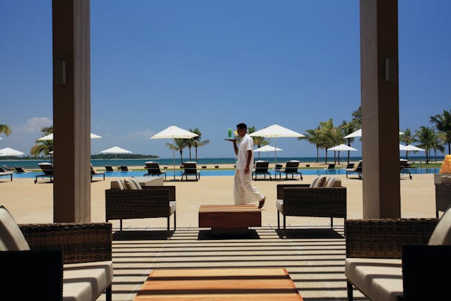 Amaya Beach Resort Sri Lanka pool terrace chairs umbrellas waiter carrying drink