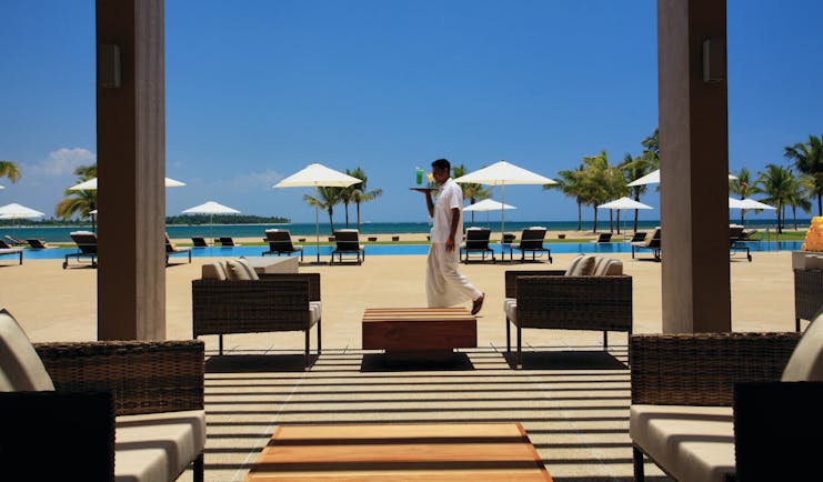 Amaya Beach Resort Sri Lanka pool terrace chairs umbrellas waiter carrying drink