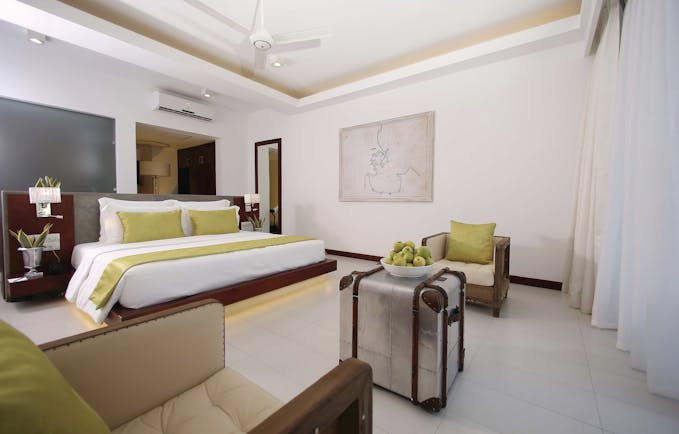 Anilana Nilaveli deluxe guestroom bed armchairs bright modern décor