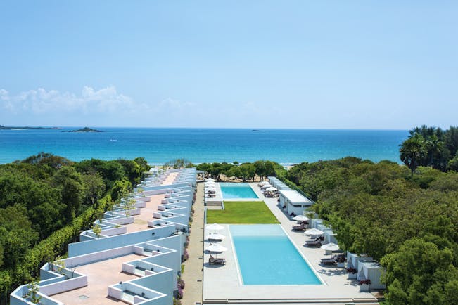 Anilana Nilaveli exterior pools terrace hotel building ocean in background