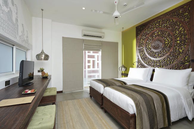 Jetwing Jaffna Sri Lanka deluxe bedroom ornate carved headboard modern décor