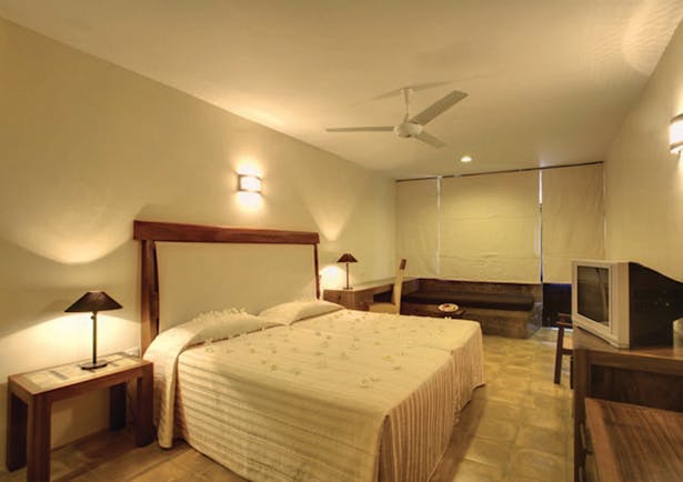 Nilaveli Beach Hotel Sri Lanka guestroom bed bench rustic décor