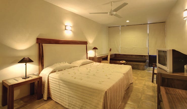 Nilaveli Beach Hotel Sri Lanka guestroom bed bench rustic décor