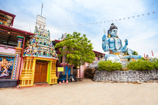 Koneswaram Temple exterior, colourful architecture, large blue god statue