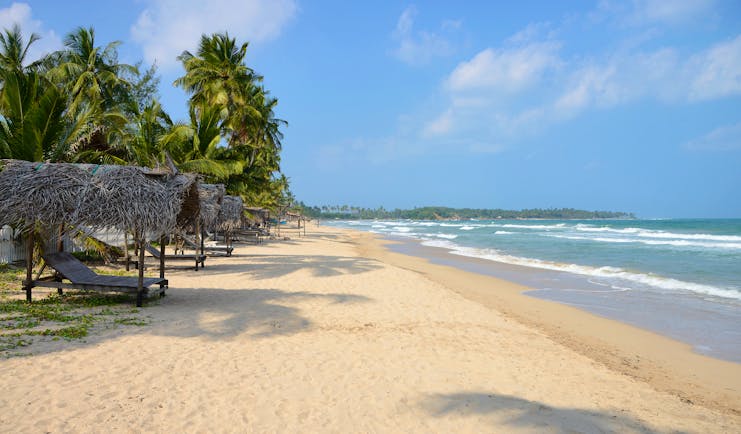 Uppuveli beach, white sand, clear blue water, palm trees