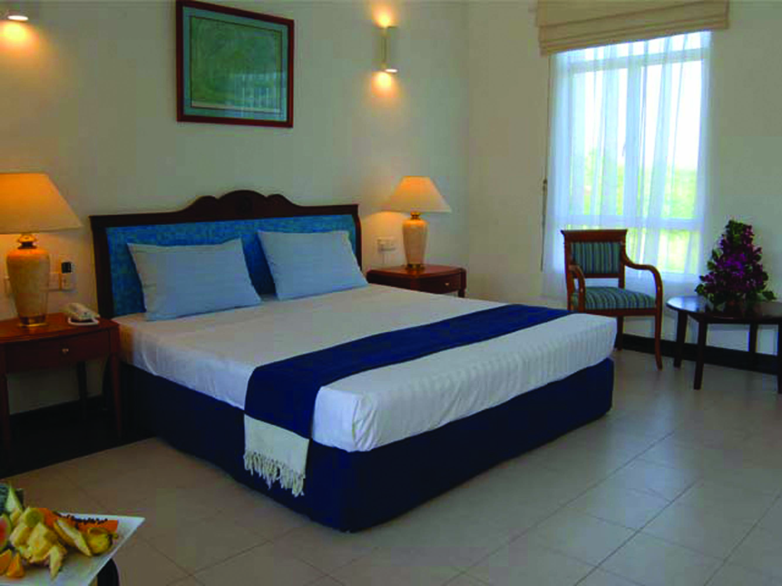 Pigeon Island Resort Sri Lanka deluxe room bed chair modern décor