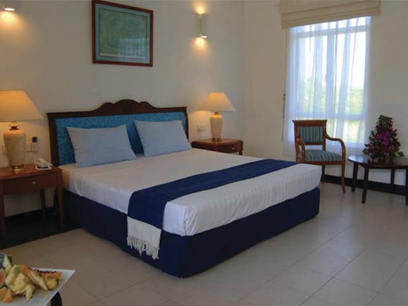 Pigeon Island Resort Sri Lanka deluxe room bed chair modern décor