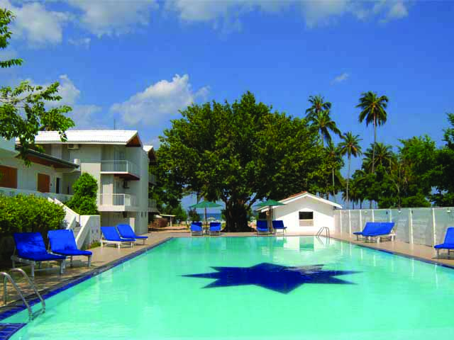 Pigeon Island Resort Sri Lanka pool sun loungers trees
