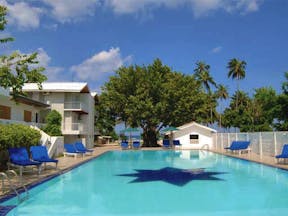 Pigeon Island Resort Sri Lanka pool sun loungers trees