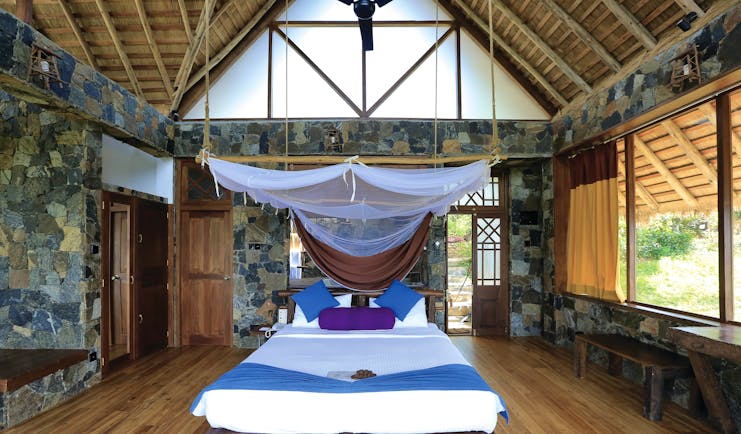 98 Acres Resort Sri Lanka honeymoon deluxe bedroom bed canopy rustic décor