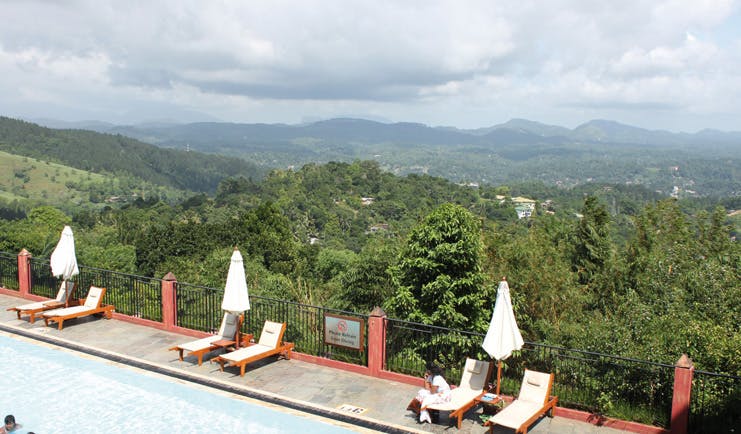Amaya Hills Sri Lanka outdoor pool sun loungers umbrellas palm covered hills