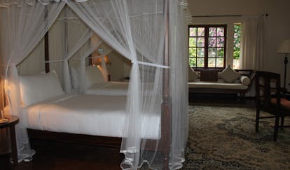Ceylon Tea Trail Sri Lanka bedroom four poster bed sofa and large window