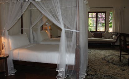 Ceylon Tea Trail Sri Lanka bedroom four poster bed sofa and large window