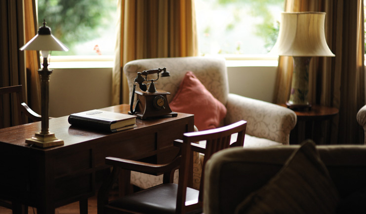 Ceylon Tea Trail Sri Lanka Castlereagh library table with old fashioned telephone armchair
