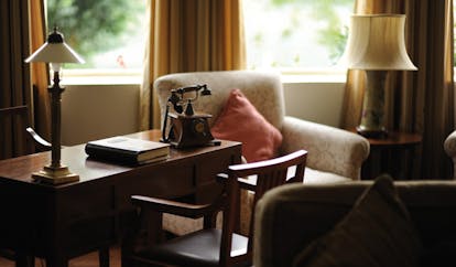 Ceylon Tea Trail Sri Lanka Castlereagh library table with old fashioned telephone armchair