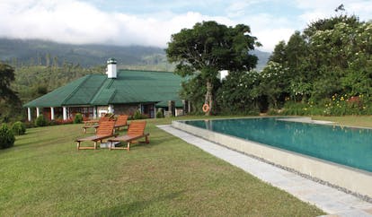 Ceylon Tea Trail Sri Lanka outdoor swimming pool loungers bungalow and mountain view