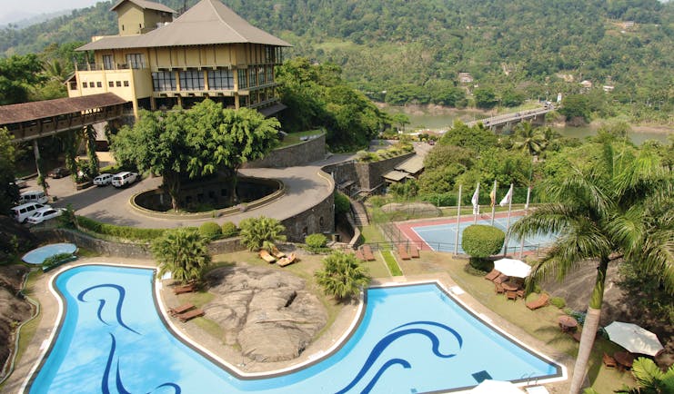 Earl's Regency Sri Lanka exterior hotel building pool tennis courts mountain in background