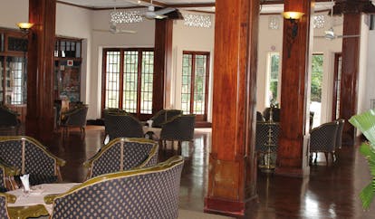 Hotel Suisse Sri Lanka lounge traditional decor wooden columns armchairs