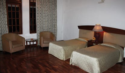 Hotel Suisse Sri Lanka twin bedroom armchairs minimalist decor