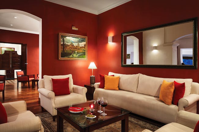 Bar area with red, cream and orange colour scheme and arm chairs set out 